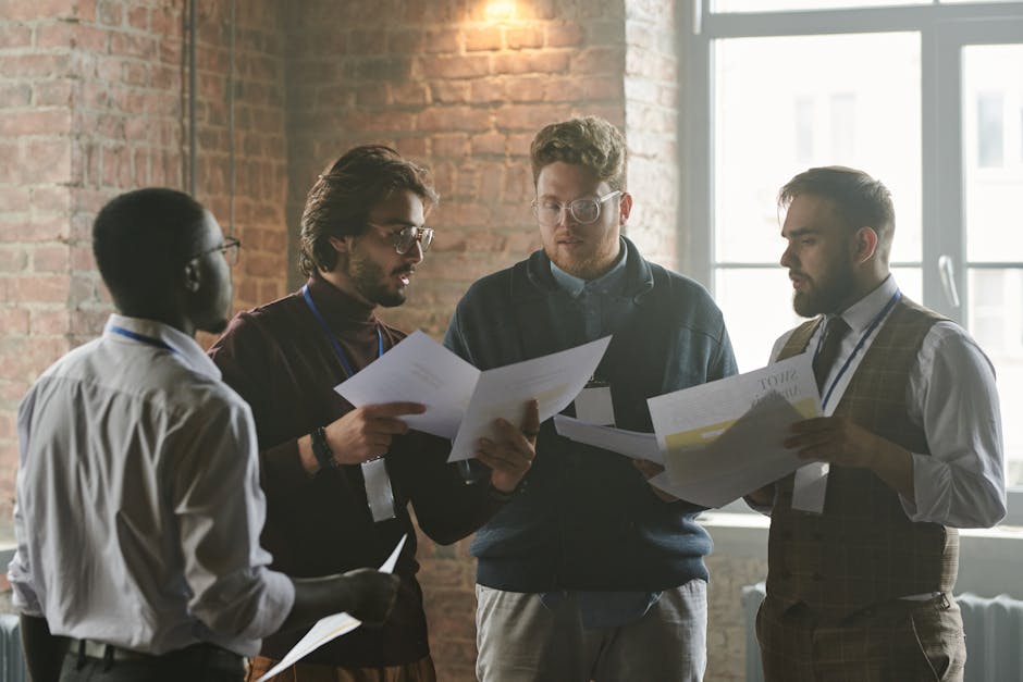 Young professionals discussing documents during a team meeting in a stylish office setting.